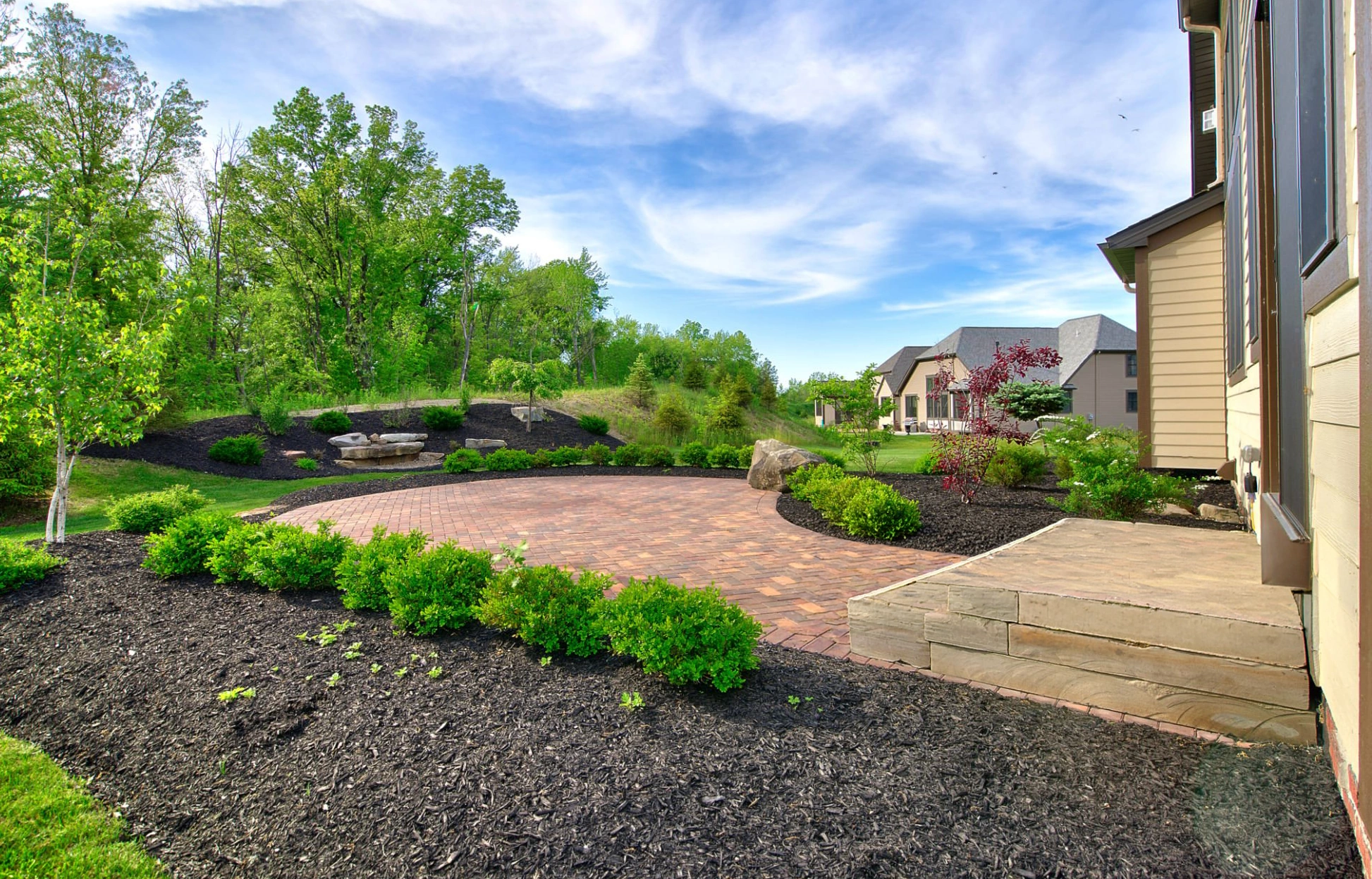Fresh mulch installed around trees and landscape beds